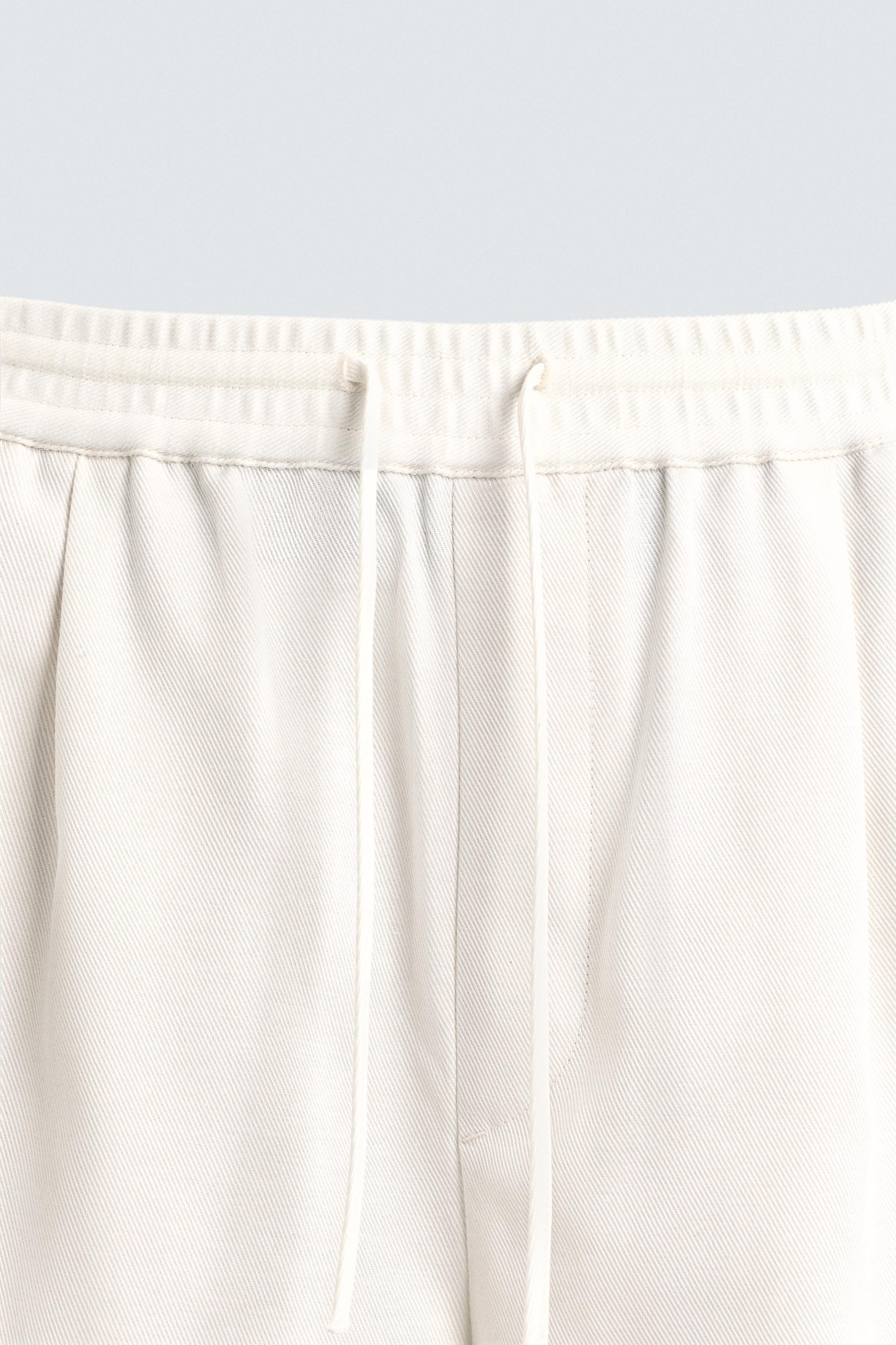 TEXTURED PLEATED PANTS